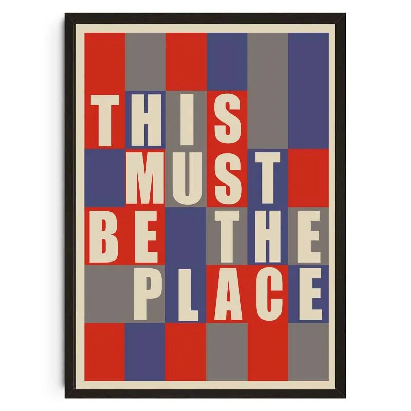 Framed poster with geometric design and text 'THIS MUST BE THE PLACE' on a white background