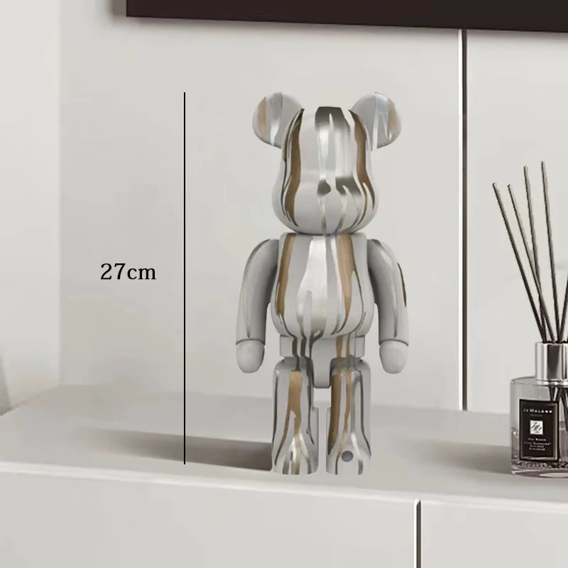 Transparent bear-shaped object on a white surface with a diffuser bottle in the background.