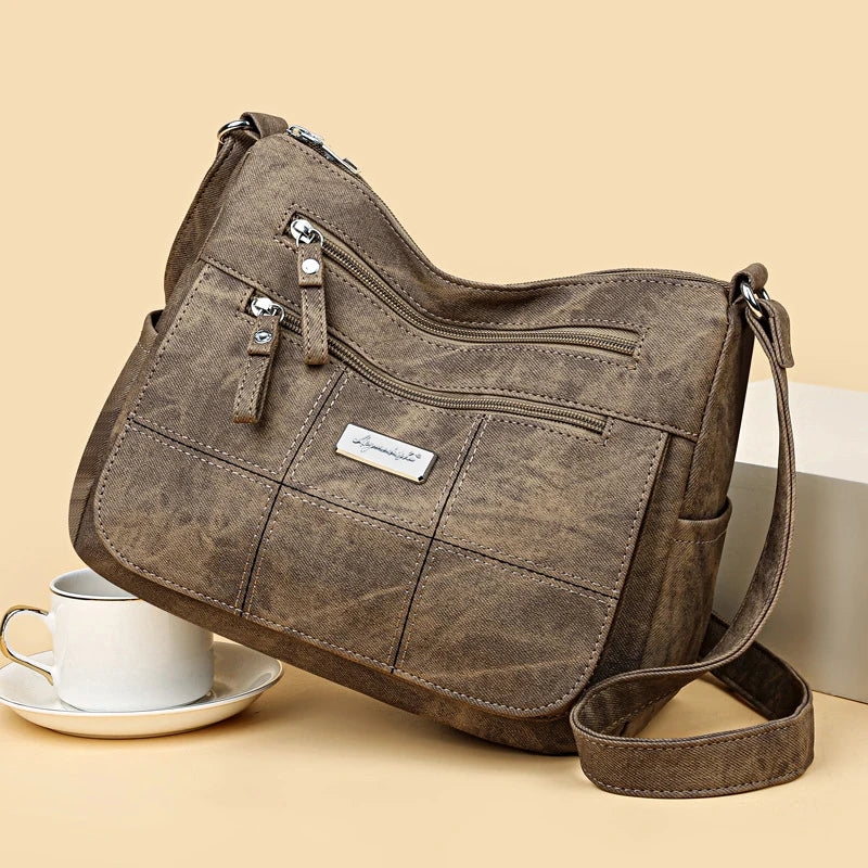 Brown handbag with a visible brand label on a beige background