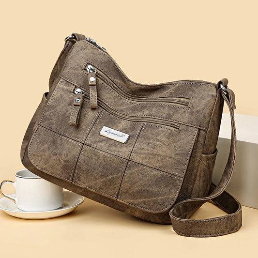 Brown handbag with a visible brand label on a beige background