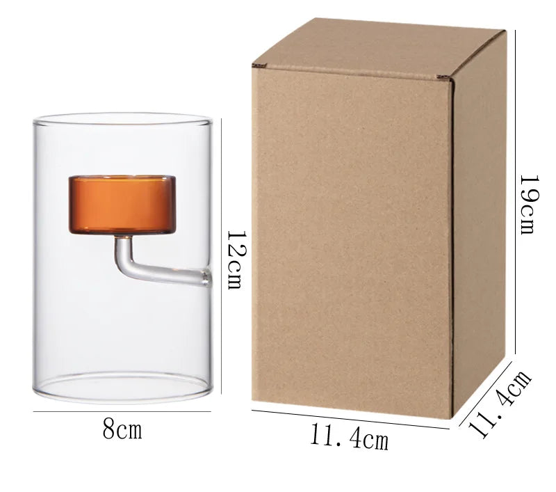 Glass product with orange accent and cardboard box with dimensions on a white background