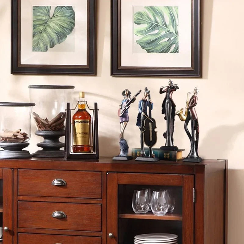 Wooden sideboard with decorative items including a bottle, statues, and glasses.