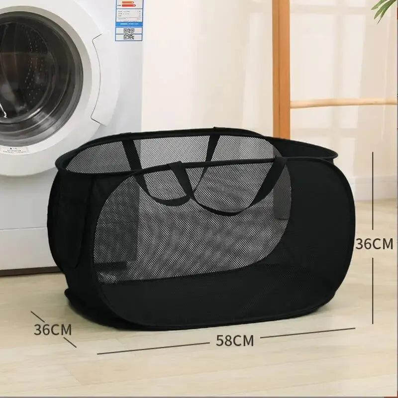 Black mesh laundry bag with dimensions in front of a washing machine.