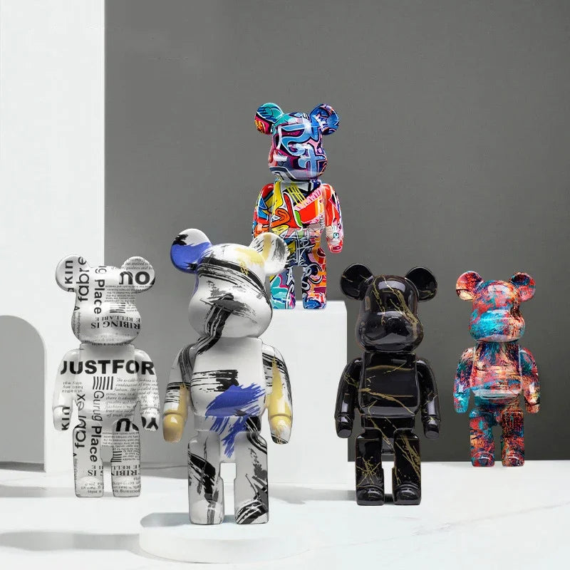 Collection of colorful and patterned bear figurines on a gray background