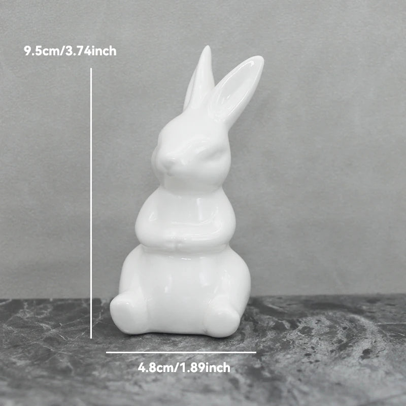 White ceramic rabbit figurine on a gray surface with measurements indicated.