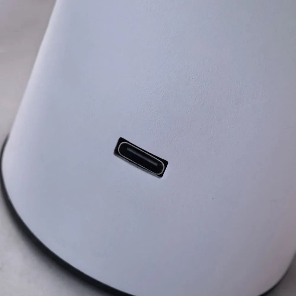 Close-up of a USB-C port on a white surface