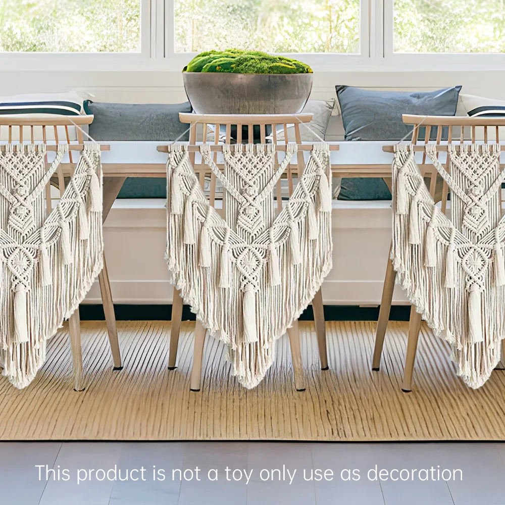 Dining table with chairs draped with macrame hangings in a bright room.