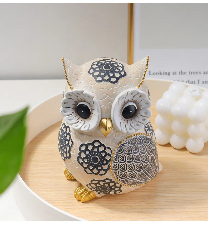 Decorative owl figurine with intricate designs on a wooden surface