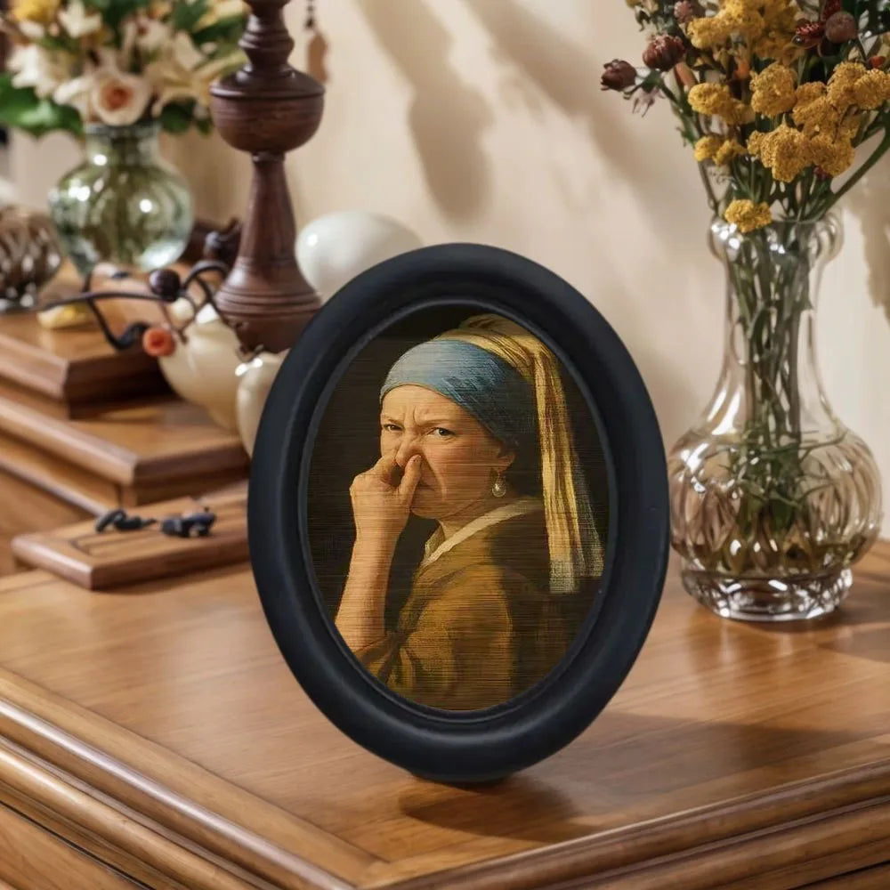 Small framed parody artwork featuring a humorous expression in a black oval frame, designed as quirky bathroom and home wall décor.