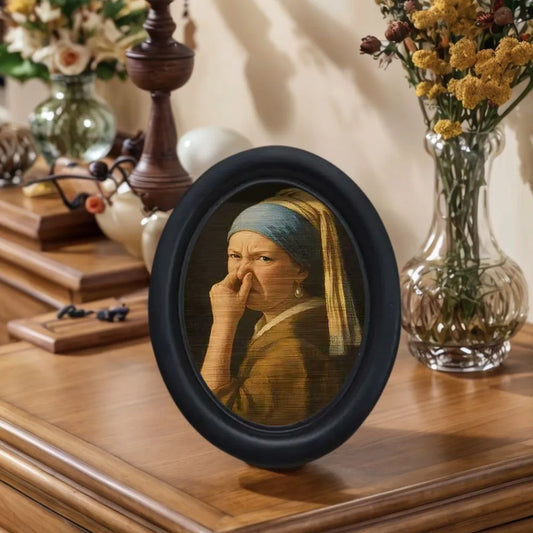 Small framed parody artwork featuring a humorous expression in a black oval frame, designed as quirky bathroom and home wall décor.