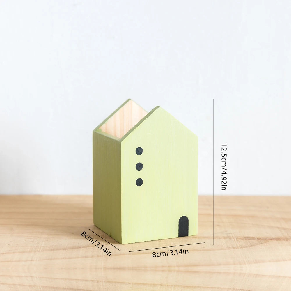 Green birdhouse with measurements on a wooden surface