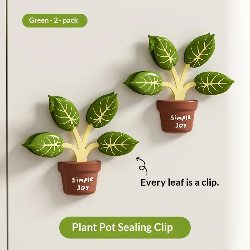 Two green plant pot sealing clips with leaves on a white background