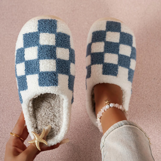 Pair of checkered slippers on a pink background