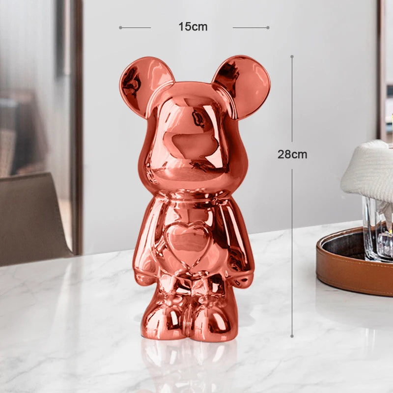 Rose gold teddy bear figurine with measurements on a white surface