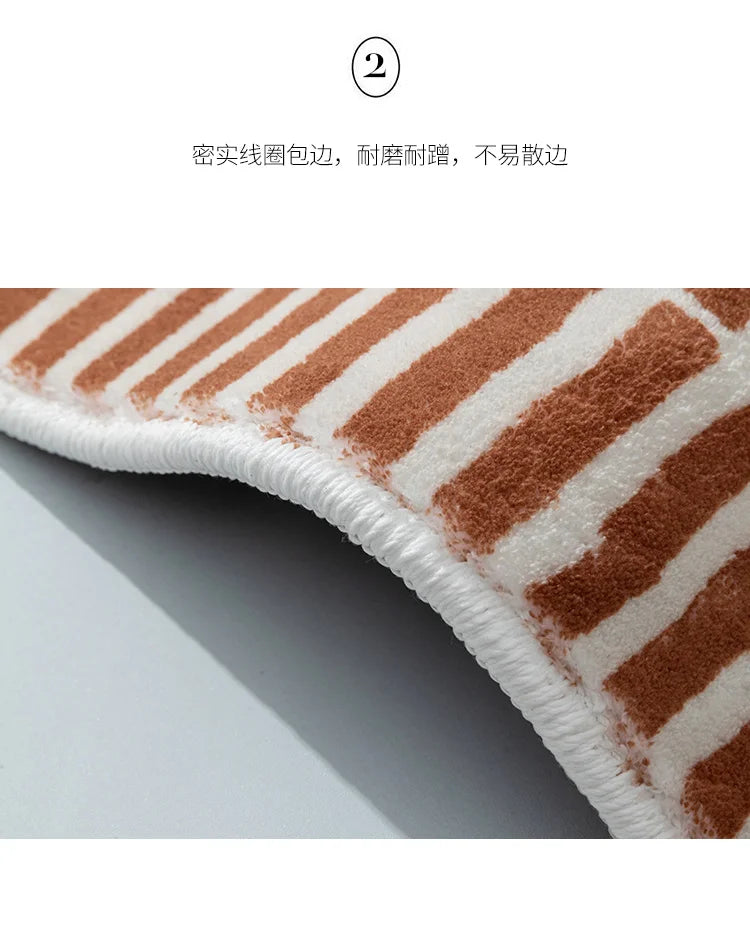 Close-up of a brown and white striped rug with a textured border on a light gray background.