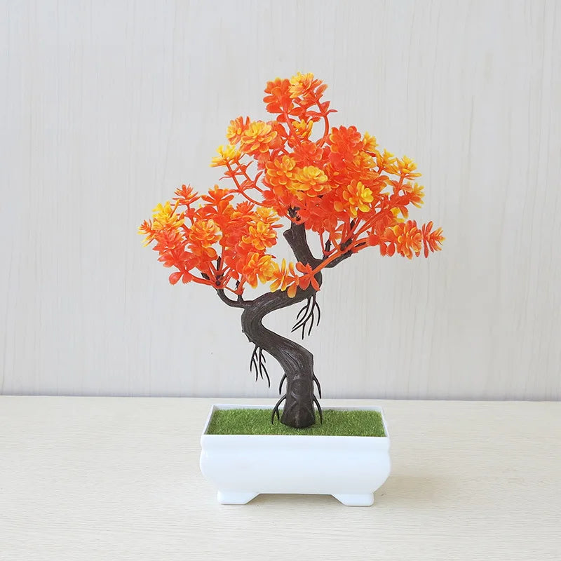 Bonsai tree with orange and yellow leaves in a white pot on a light background