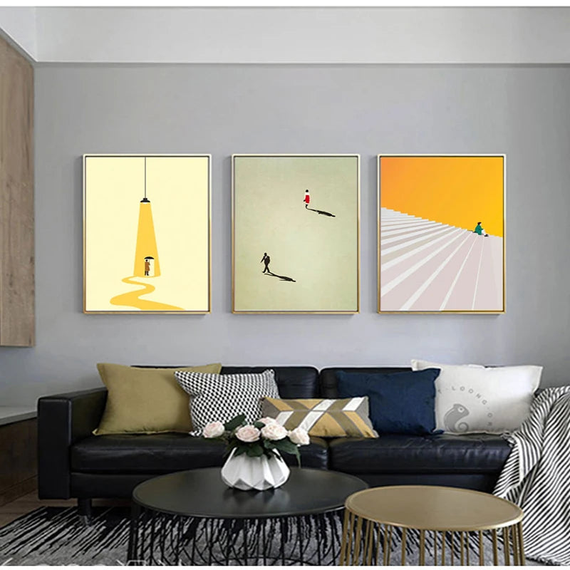 Minimalist figure art posters in soft colours displayed above a sofa