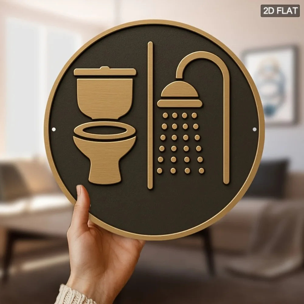 Round sign with toilet and shower icons held by a hand in a blurred indoor setting