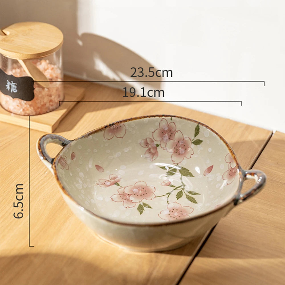 Ceramic bowl with floral design on a wooden surface, showing measurements.