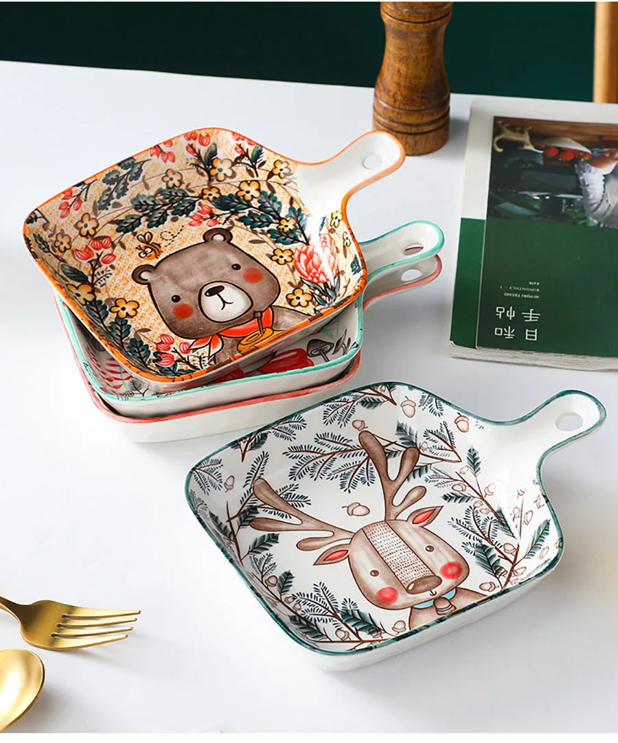 Set of square ceramic plates with animal designs on a white surface.
