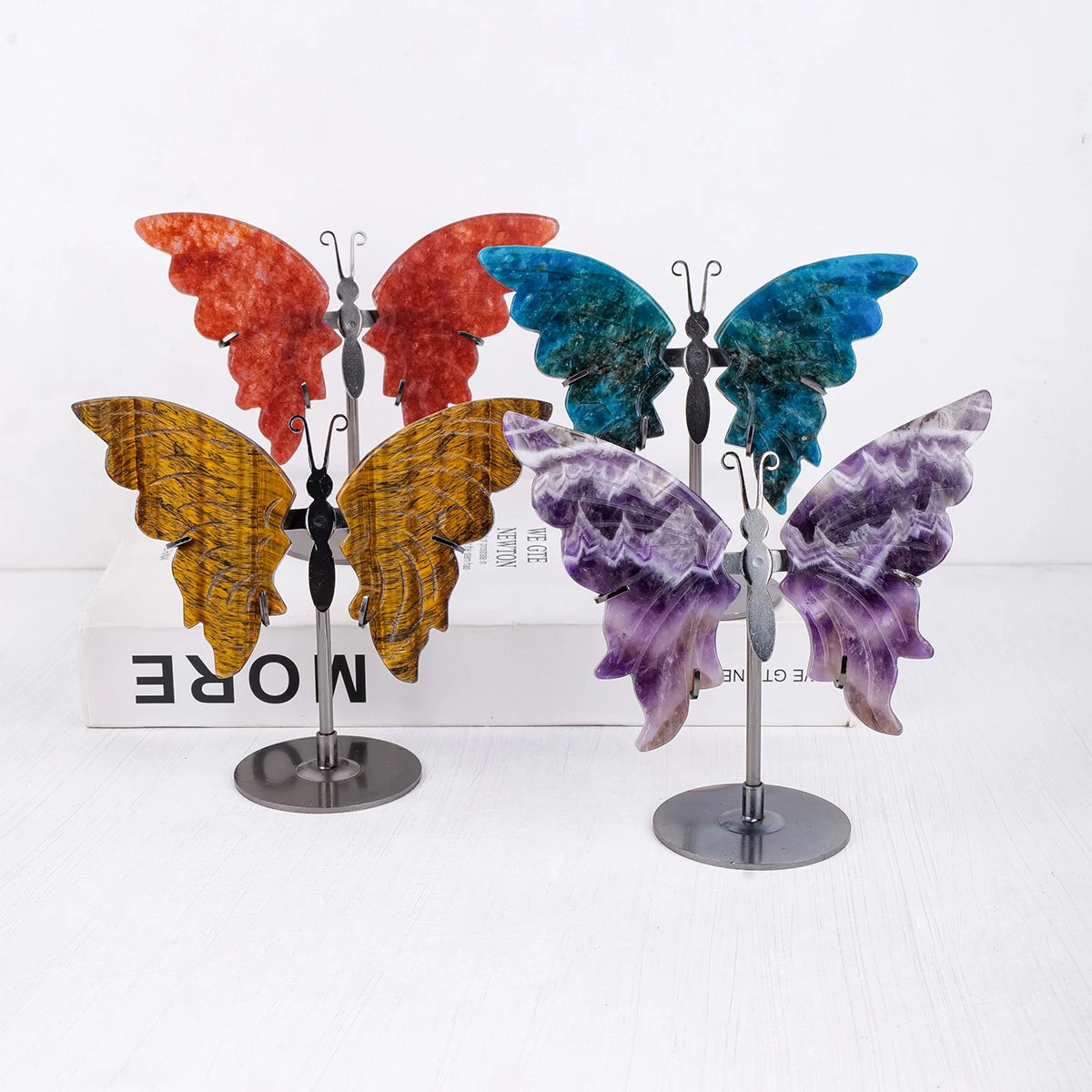 Colorful butterfly-shaped ornaments on a white background with 'MORE' text.