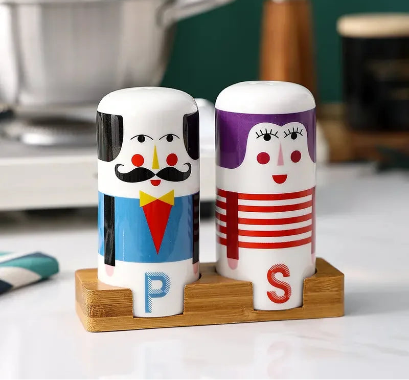 Creative ceramic salt and pepper shaker set with character faces displayed on a wooden holder for stylish kitchen and dining table decor.