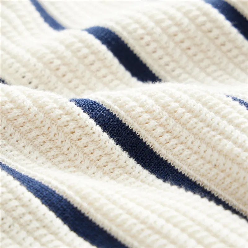 Close-up of a textured fabric with blue stripes on a white background