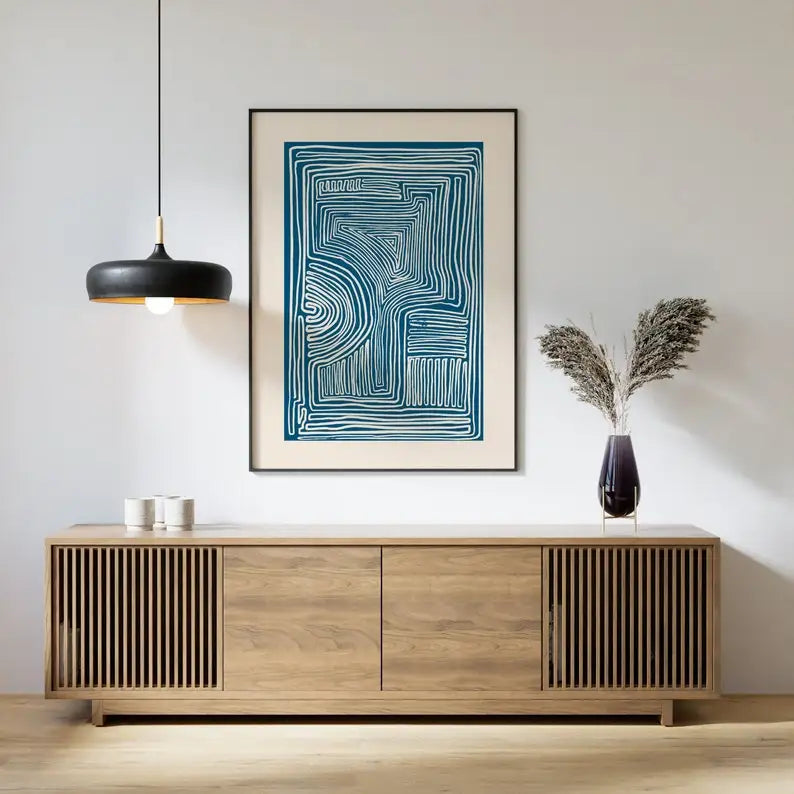 Modern living room with wooden sideboard, abstract art, and decorative vase.