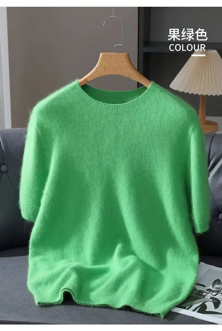 Green sweater on a hanger with 'COLOUR' text in the background