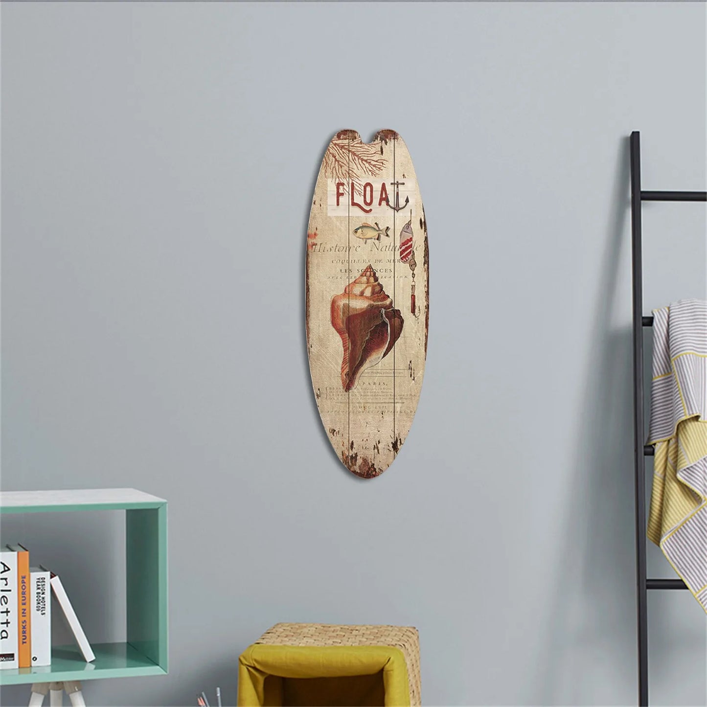 Decorative surfboard with 'FLOAT' and conch shell design on a gray wall.