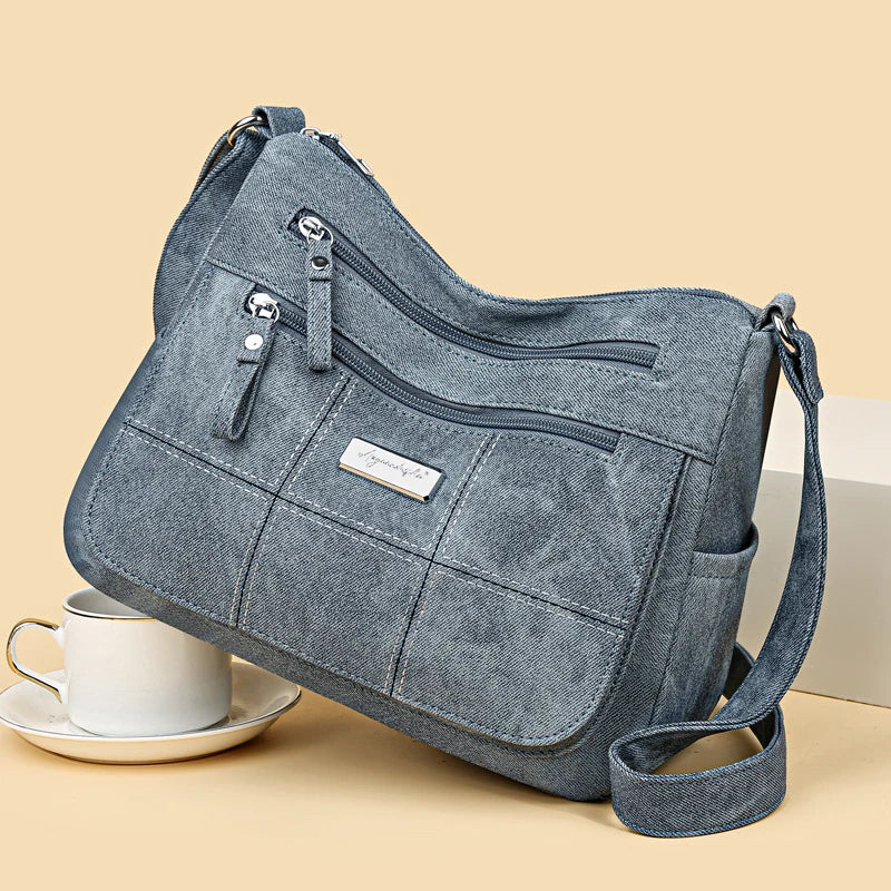 Blue handbag with a visible brand logo on a beige background