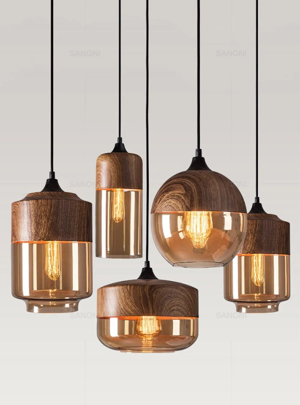 Set of five wooden pendant lights with glass shades on a light gray background