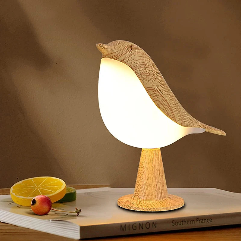 Wooden bird-shaped lamp on a book with a brown background