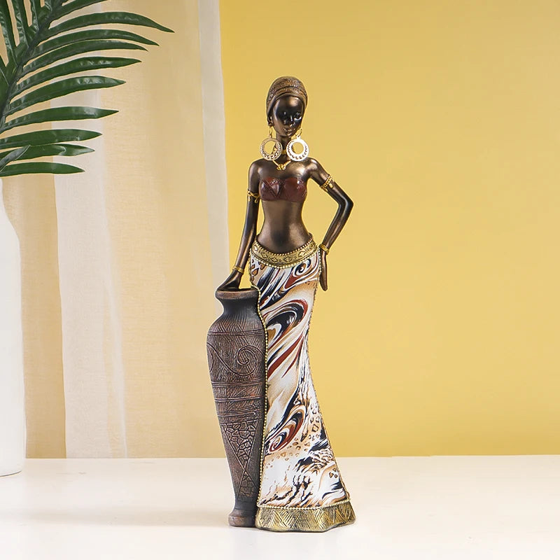 Decorative statue of a woman holding a vase against a yellow wall with a plant on the left.