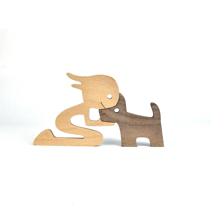 Wooden figurines of a person and a dog on a white background