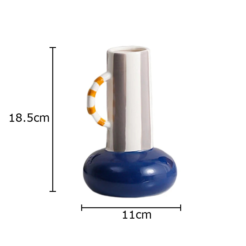 A ceramic vase with a wide navy blue base, a tall glossy white neck, and a white handle accented with orange stripes, shown with dimension lines indicating a height of 18.5cm and width of 11cm on a white background.