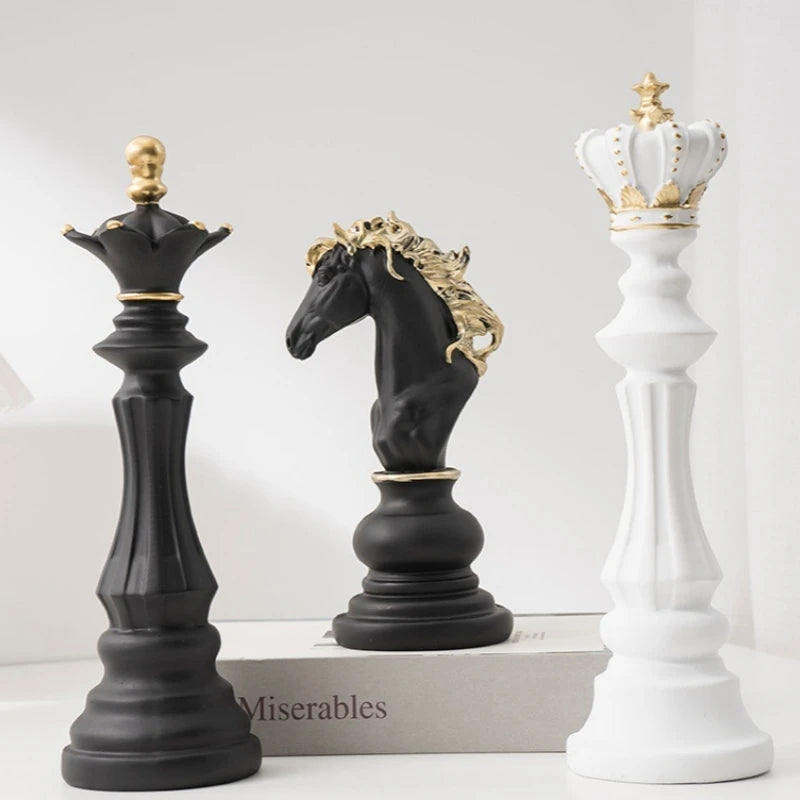Decorative chess pieces including a black king, black horse, and white queen on a white background.