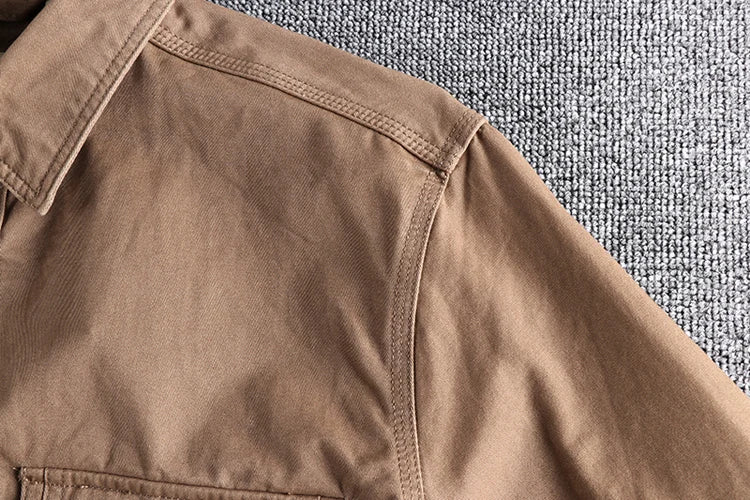 Close-up of a brown jacket on a textured gray surface