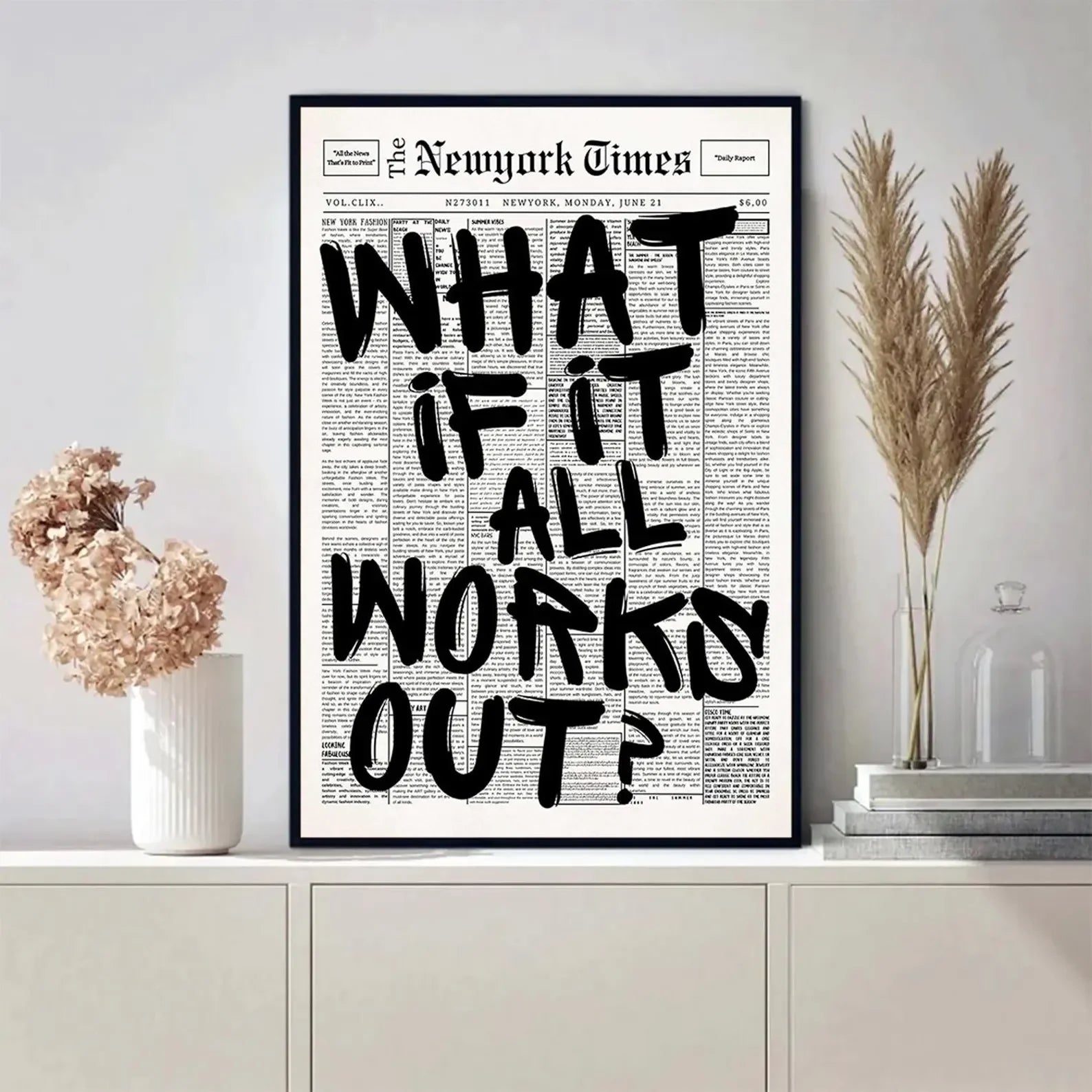 Framed New York Times newspaper with 'What if it all works out?' quote on a wall.