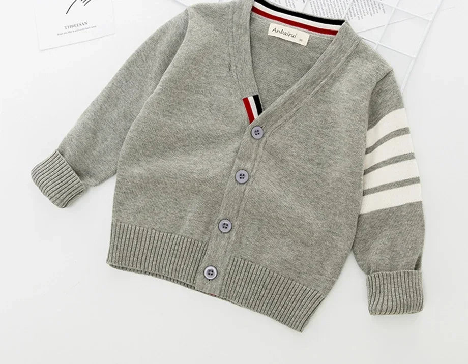 Gray children's cardigan with striped sleeves on a white background