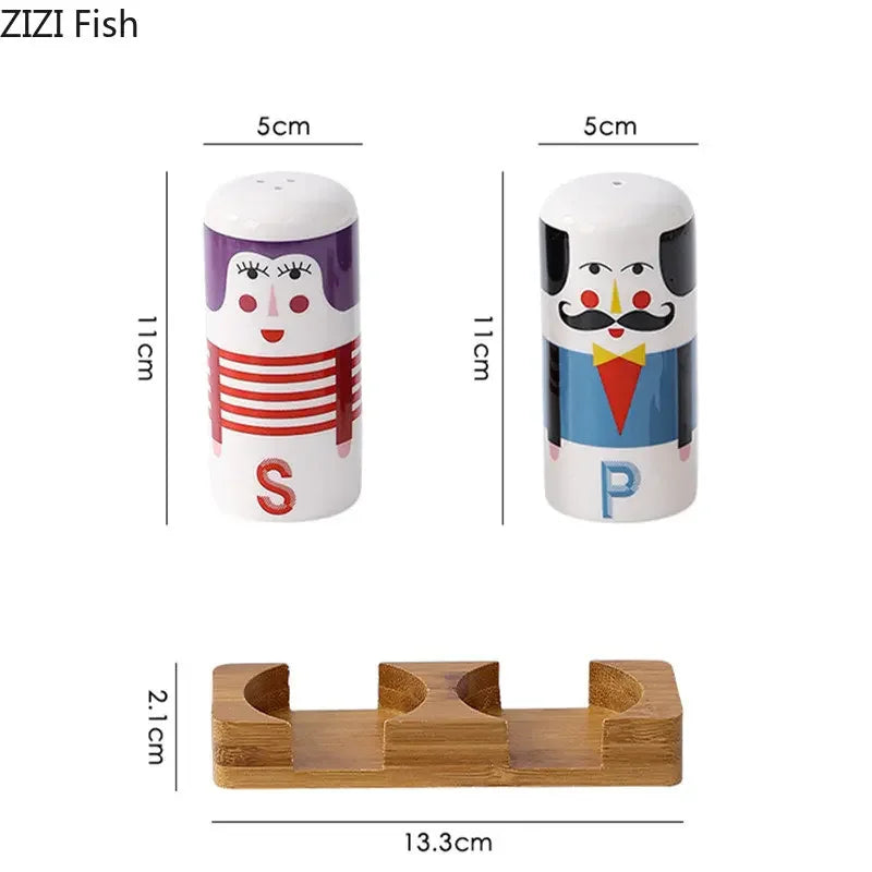 Two cartoon-themed salt and pepper shakers with a wooden stand, showing measurements.
