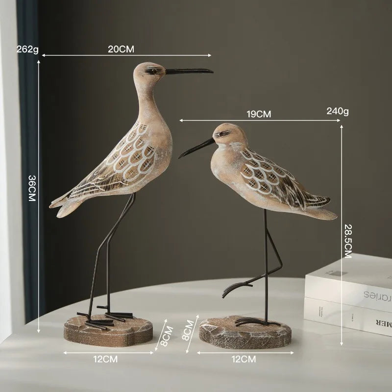 Two decorative bird figures with measurements on a plain background