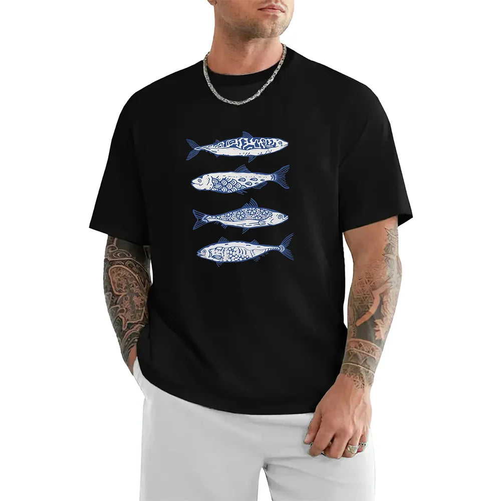 Man wearing a black t-shirt with blue fish designs on a white background