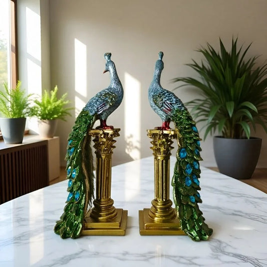 Pair of peacock ornaments standing on decorative Roman columns with detailed colourful feathers.