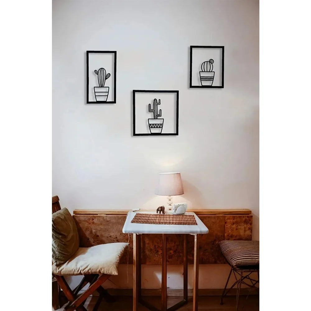 Living room with wall art of cacti, a table, and chairs.