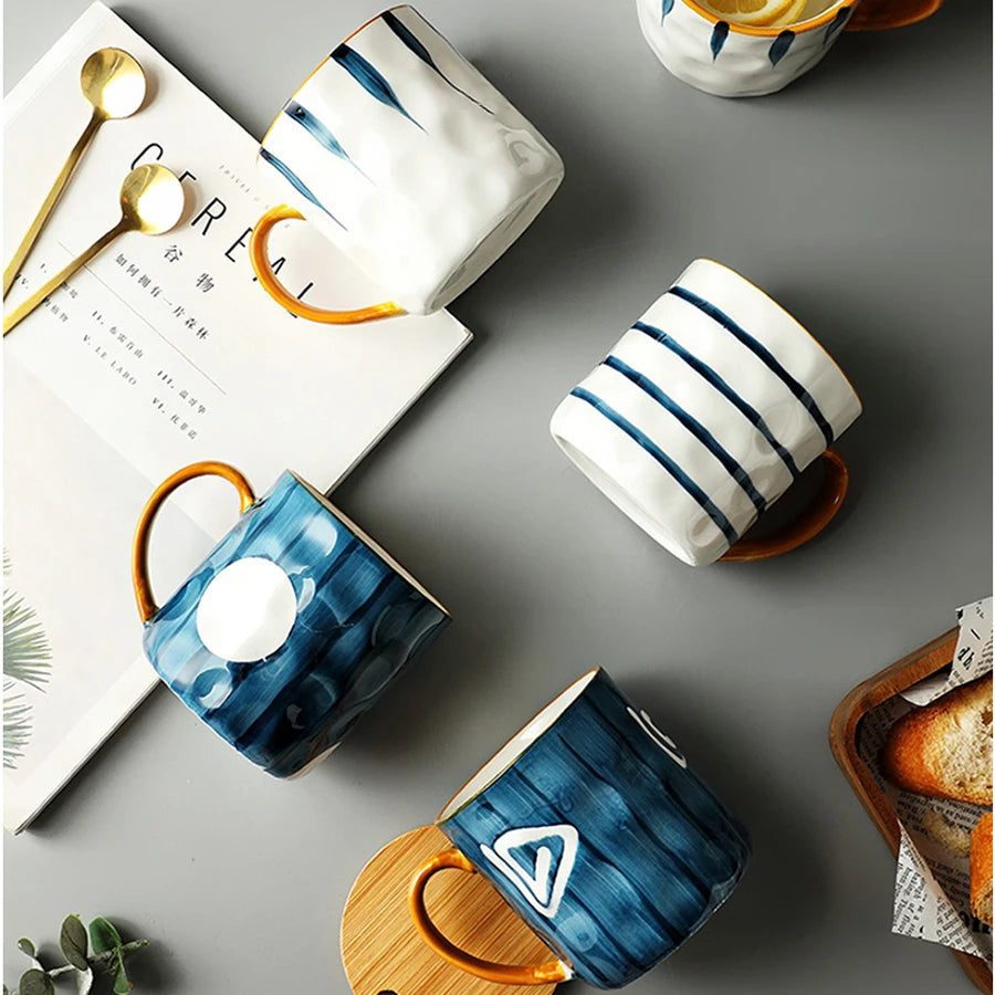 Collection of ceramic mugs with blue and white designs on a gray surface.
