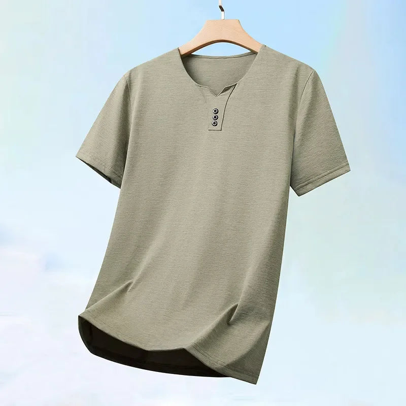 Green t-shirt on a hanger with a light blue background