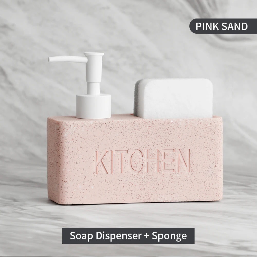 Pink sand kitchen soap dispenser with pump and sponge on a gray background