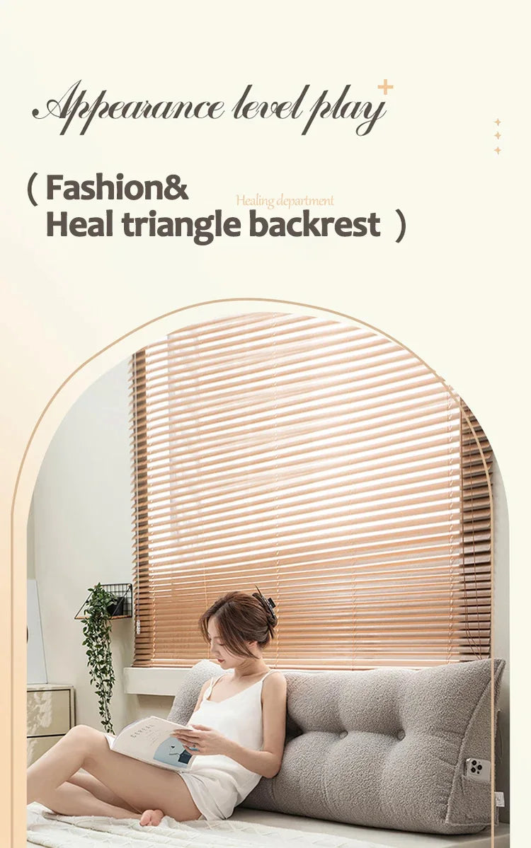 Woman sitting on a couch with a triangular backrest in a room with a large mirror.