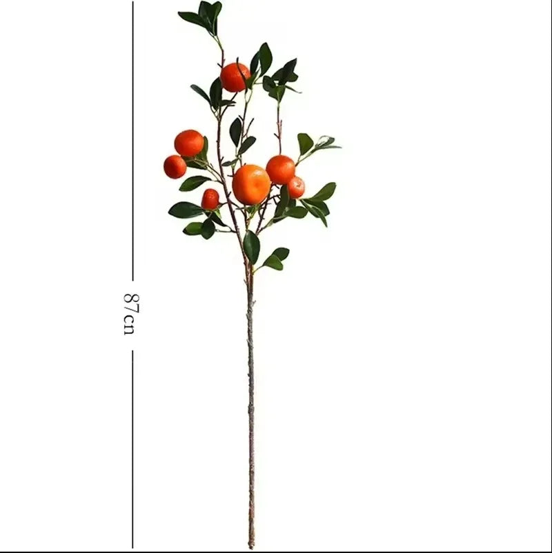 Artificial plant branch with orange fruits and green leaves, shown with a measurement of 87cm on a white background.